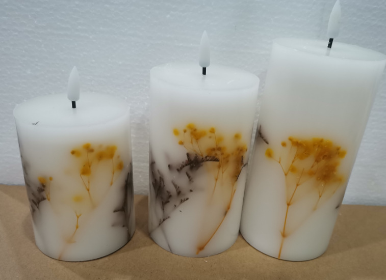 Yellow floral wax candles in three heights